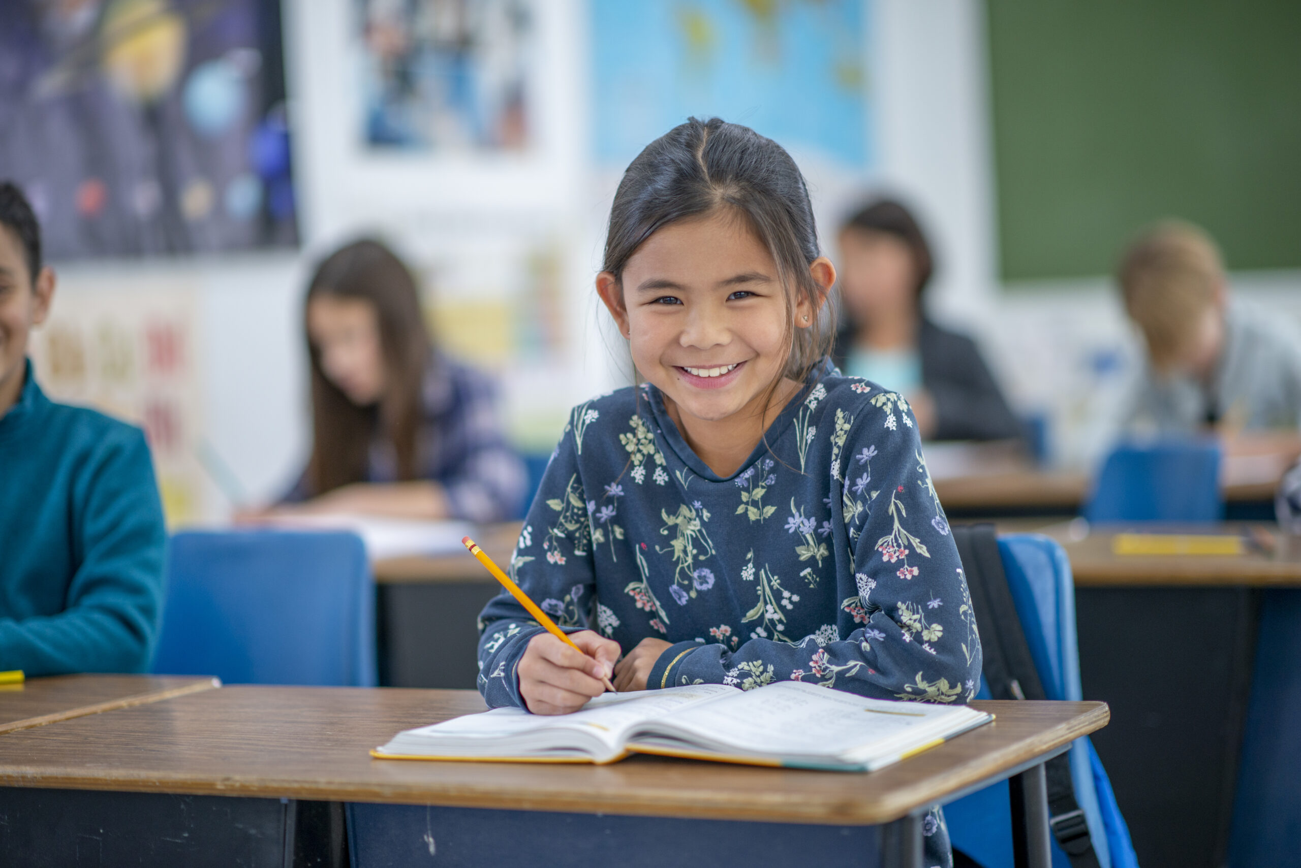 An image of a young student listening eagerly while taking a test, demonstrating the activities students engage in at LRCA.